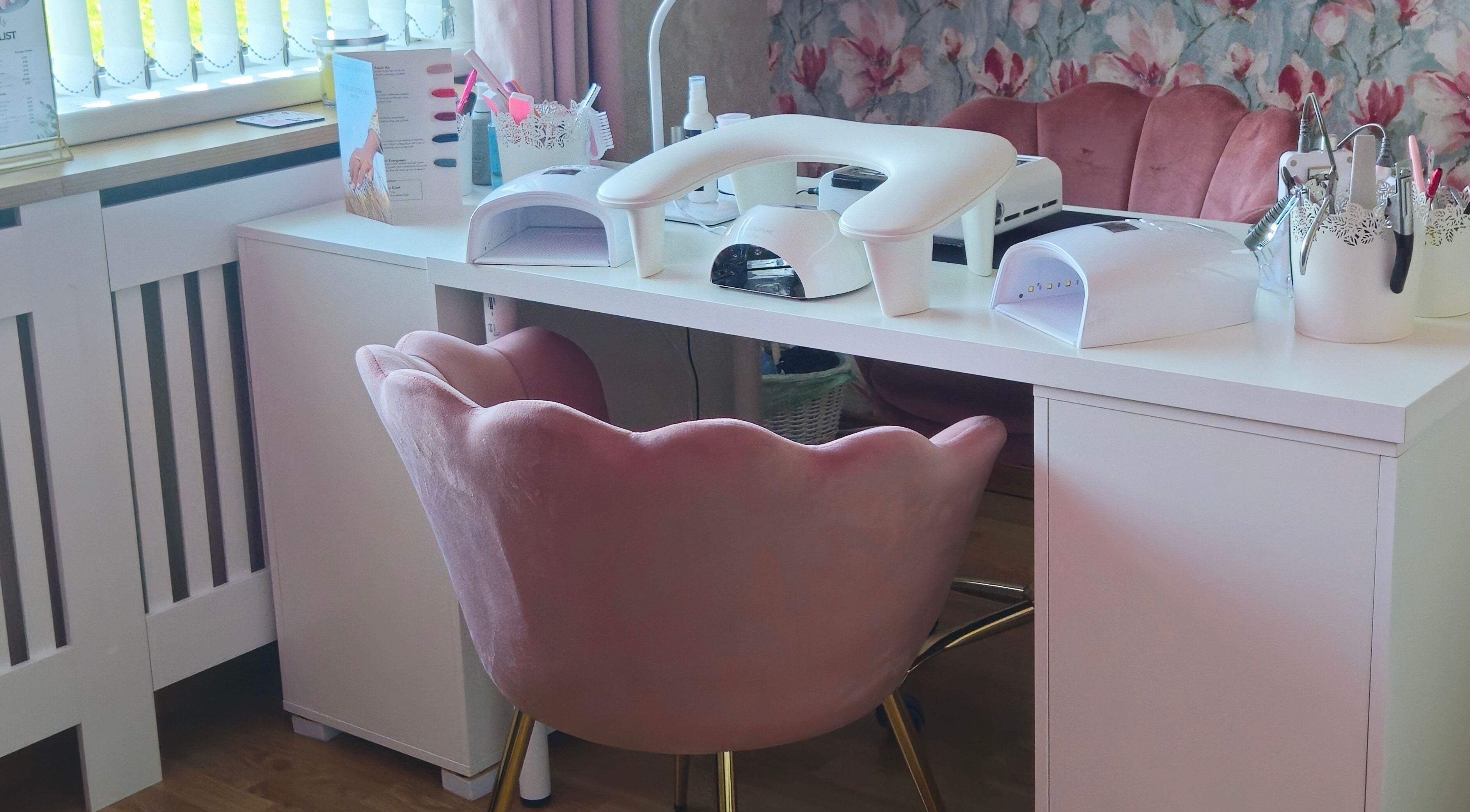 Elegant nail station at O'Nails, Newry, Northern Ireland, GB with plush pink chairs and manicure equipment.