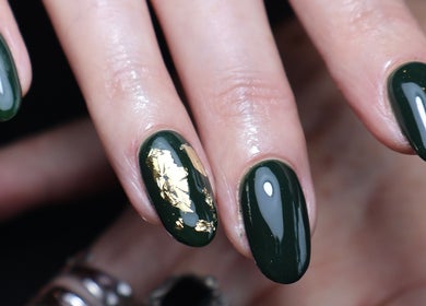 Close-up of green and gold nail art at O'Nails, Newry, Northern Ireland, GB. Perfect for a stylish look.