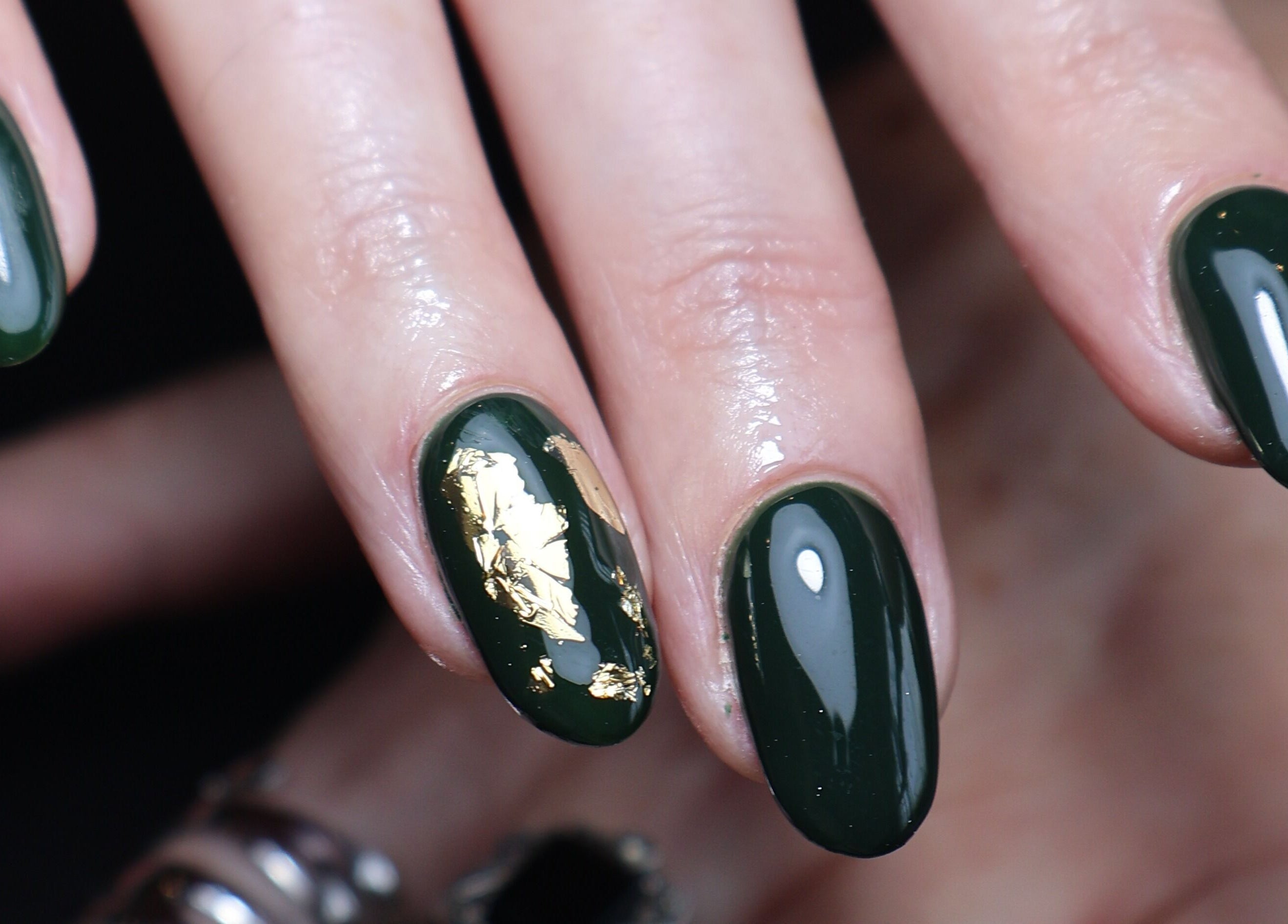 Close-up of green and gold nail art at O'Nails, Newry, Northern Ireland, GB. Perfect for a stylish look.