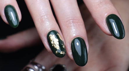 Close-up of green and gold nail art at O'Nails, Newry, Northern Ireland, GB. Perfect for a stylish look.