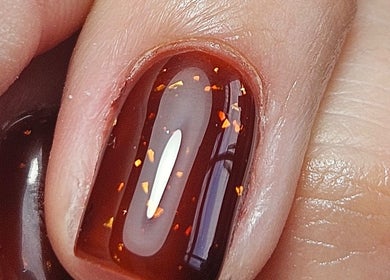 Close-up of glossy, dark red nail with sparkles at O'Nails, Newry, Northern Ireland, GB.