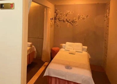 Serene massage room at RoyalwayTCM 御道中医, Singapore, SG. Cozy table with soft lighting and elegant decor.