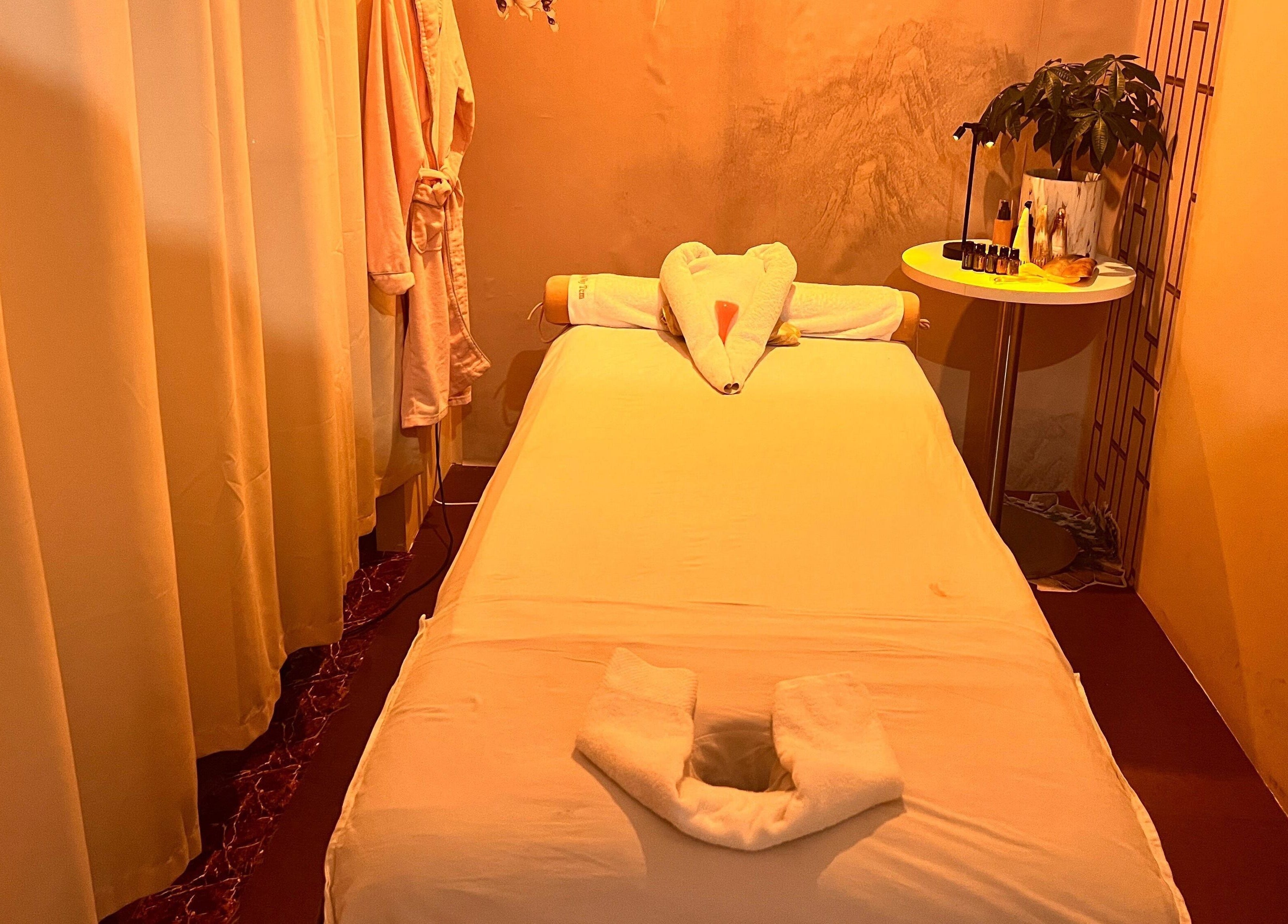 Cozy massage room at RoyalwayTCM 御道中医, Singapore, featuring a serene setup with warm lighting.