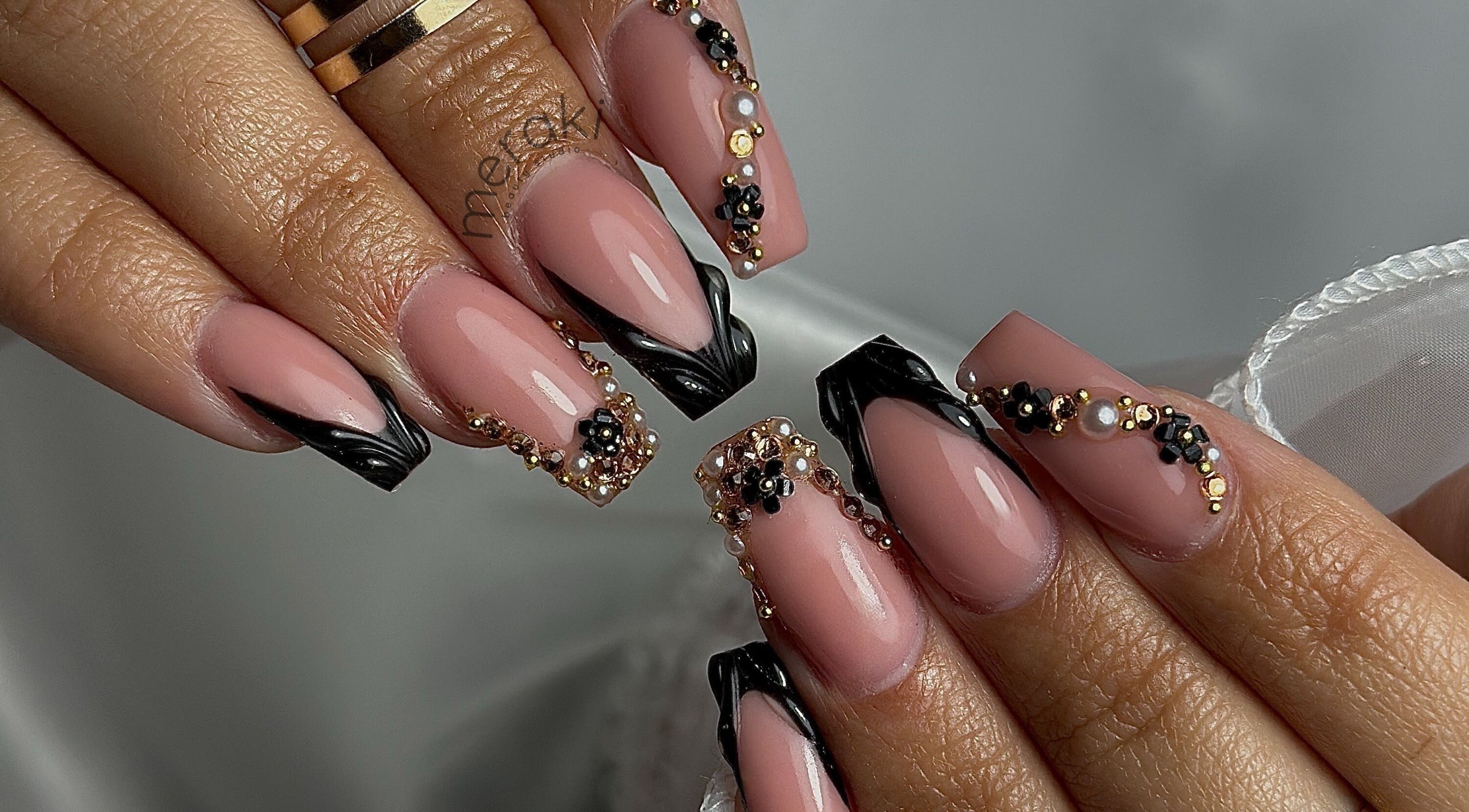 Detailed nail art with black and gold designs at Meraki Beauty Studio, Liverpool, England, GB.