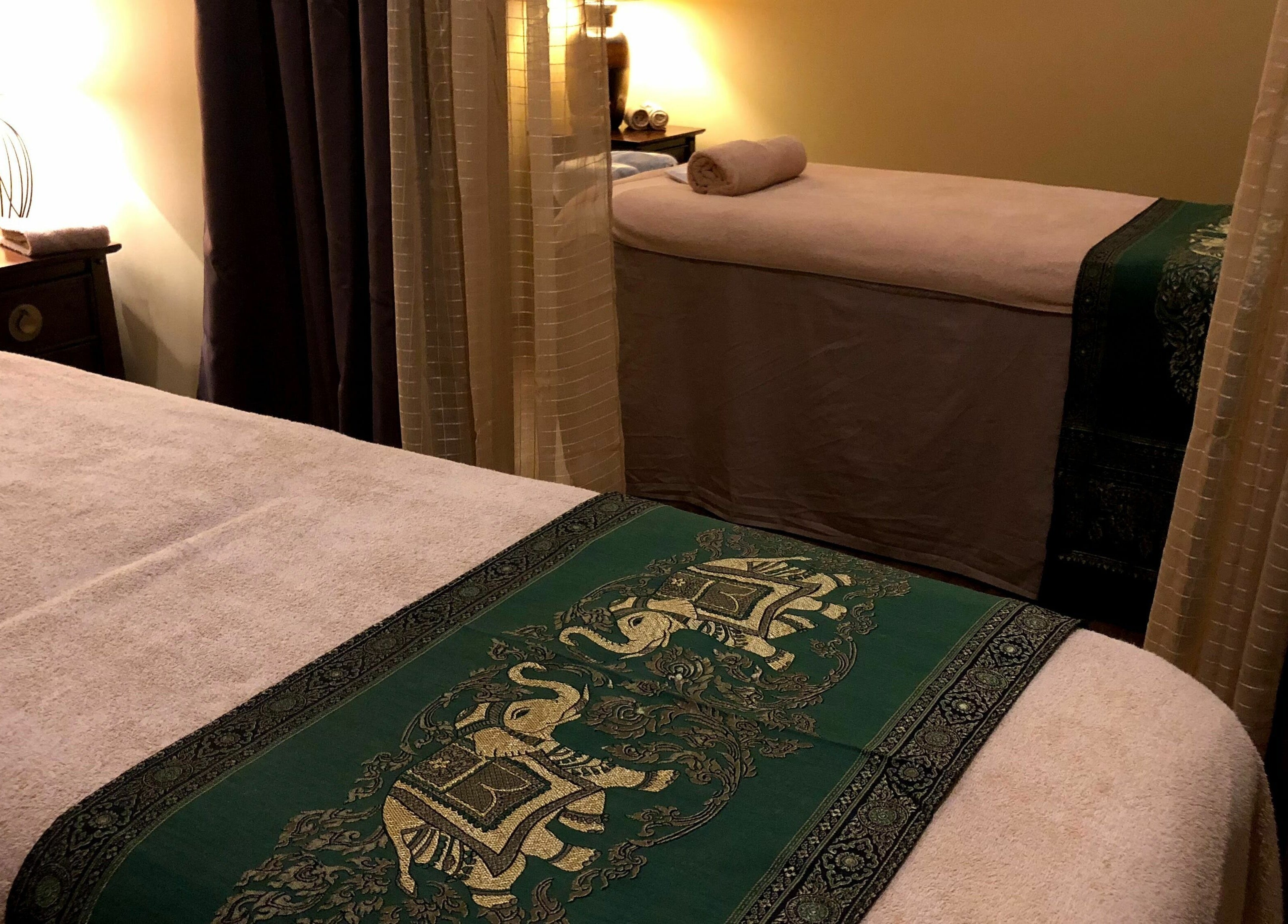 Relaxing treatment room at Natural Palm Day Spa, Cairns City, Queensland, AU with cozy decor and massage tables.