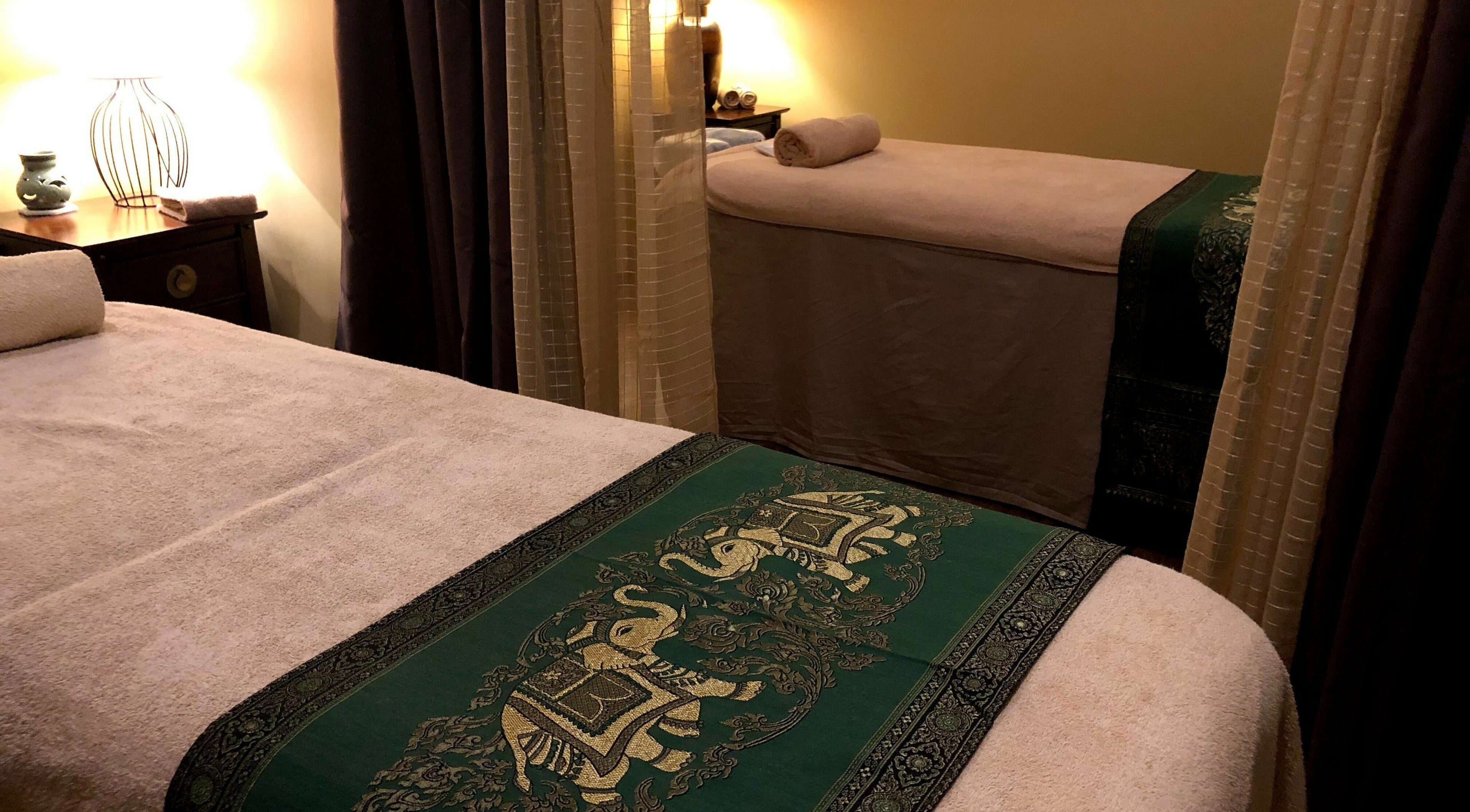 Relaxing treatment room at Natural Palm Day Spa, Cairns City, Queensland, AU with cozy decor and massage tables.