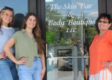 Team smiling at The Skin Bar and Body Boutique LLC entrance, Johnson City, Tennessee, US.