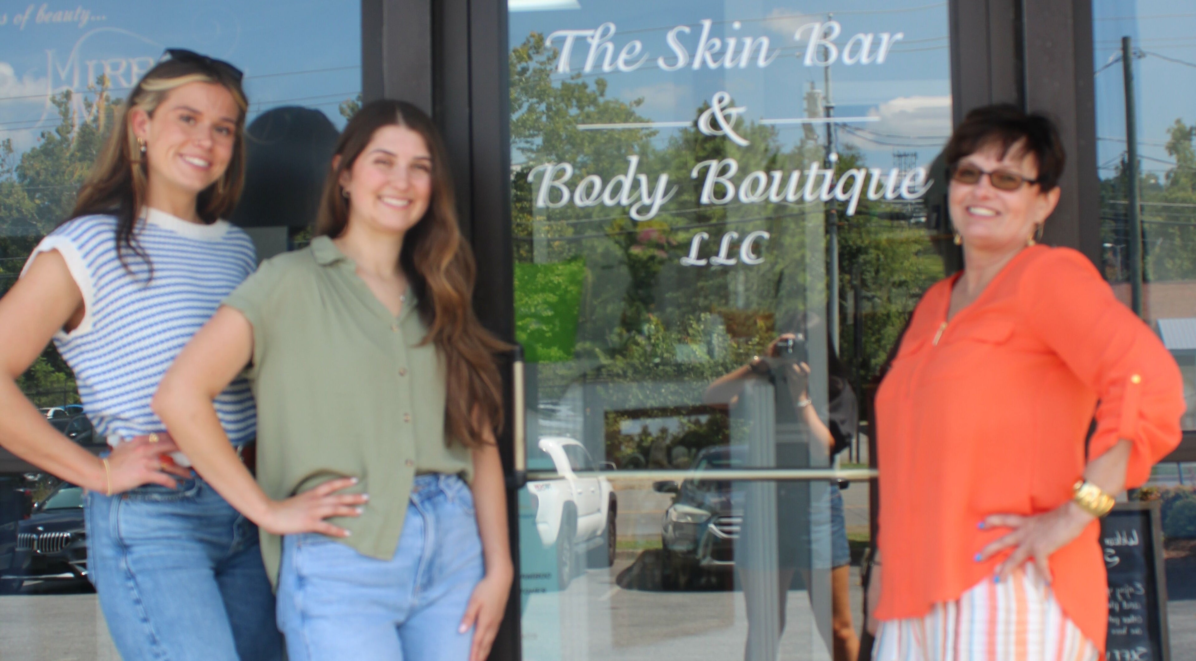 Team smiling at The Skin Bar and Body Boutique LLC entrance, Johnson City, Tennessee, US.