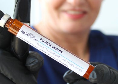 A professional holds HydroPeptide Power Serum at The Skin Bar and Body Boutique LLC in Johnson City, Tennessee, US.
