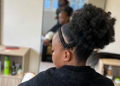 Elegant braided updo at Vanity Beauty Bar in Pretoria, Gauteng, ZA. Experience professional hair styling.