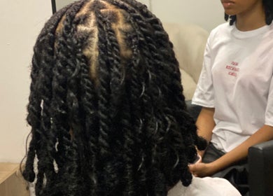 Twist braids hairstyle at Vanity Beauty Bar in Pretoria, Gauteng, ZA. Perfect finish for a modern look.