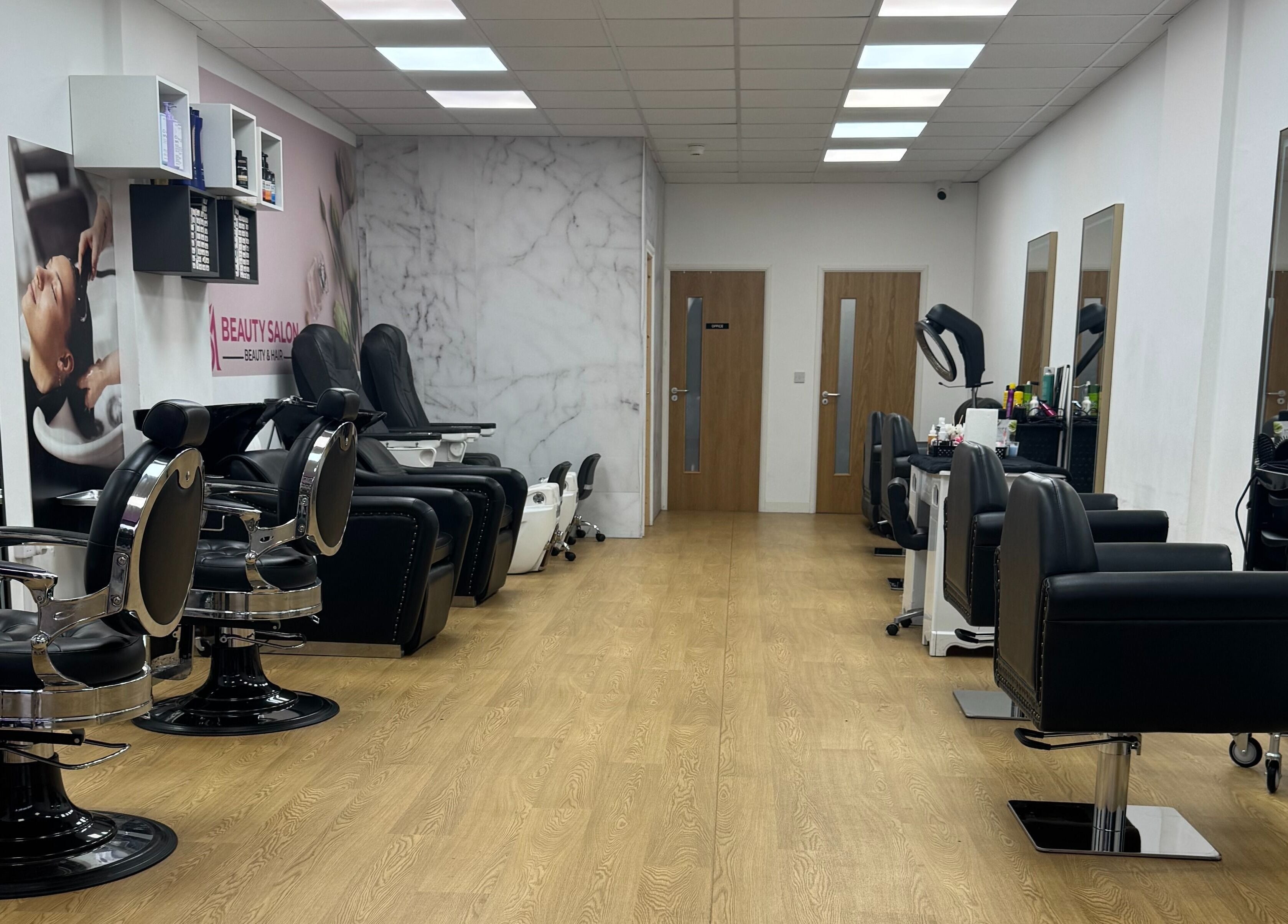 Chic interior of MS Beauty Salon in Luton, England, GB with modern styling chairs and mirrors.