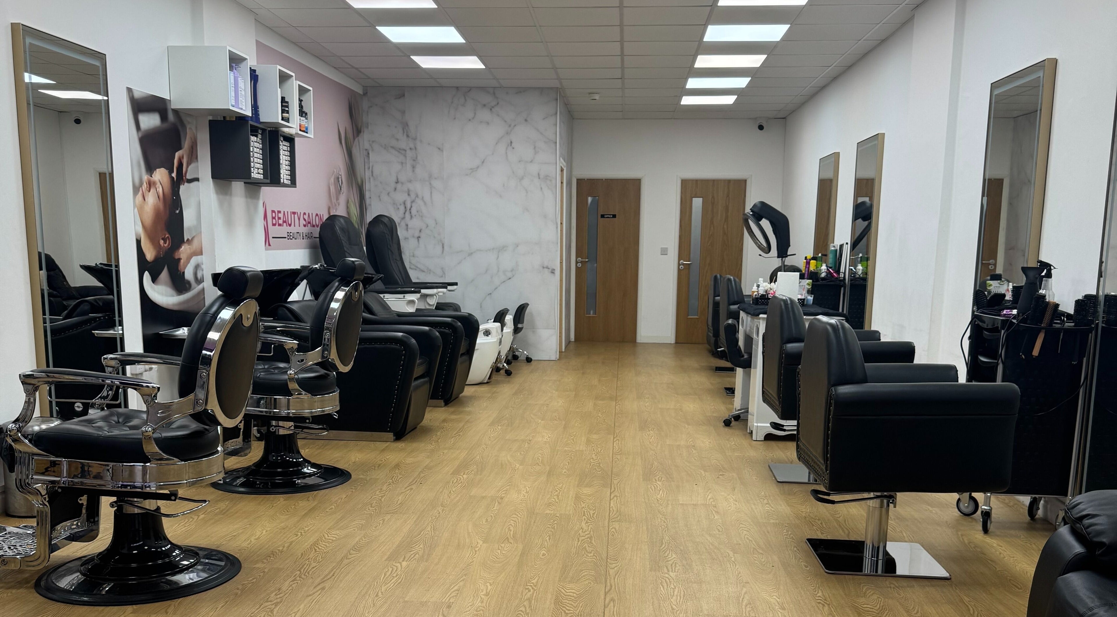 Chic interior of MS Beauty Salon in Luton, England, GB with modern styling chairs and mirrors.