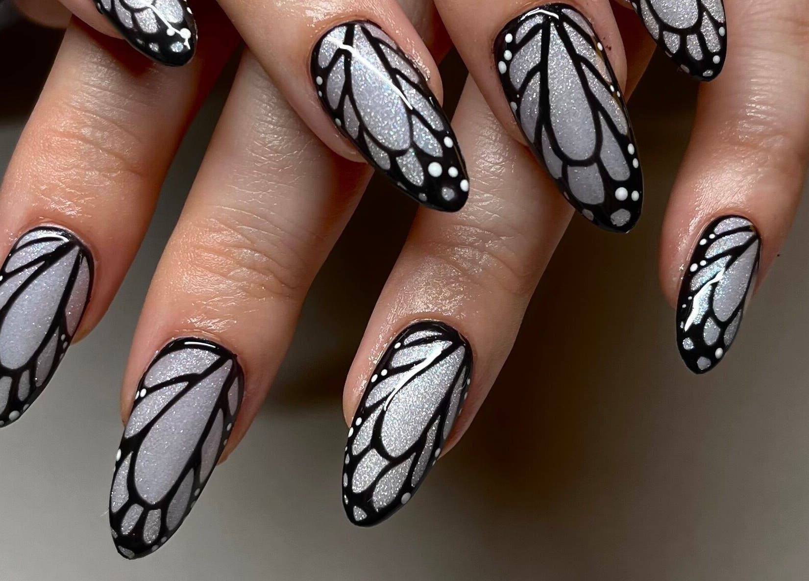 Intricate butterfly nail art at Samanails in Broughshane, Northern Ireland, GB. Perfect blend of elegance and style.