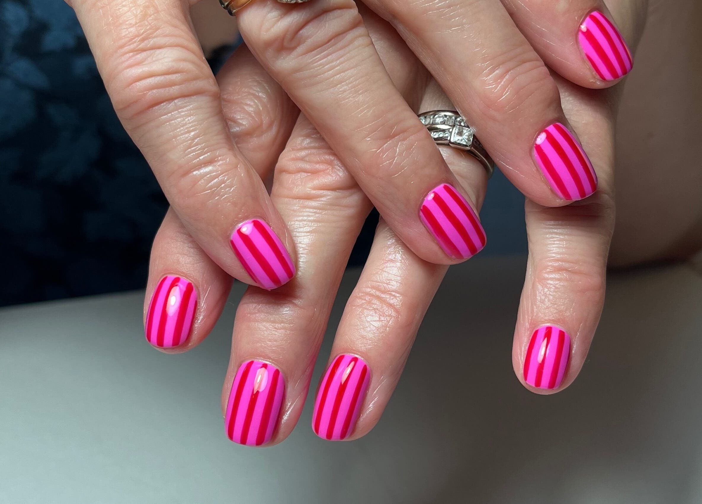 Pink striped manicure at Samanails in Broughshane, Northern Ireland, GB showing elegant nail art.