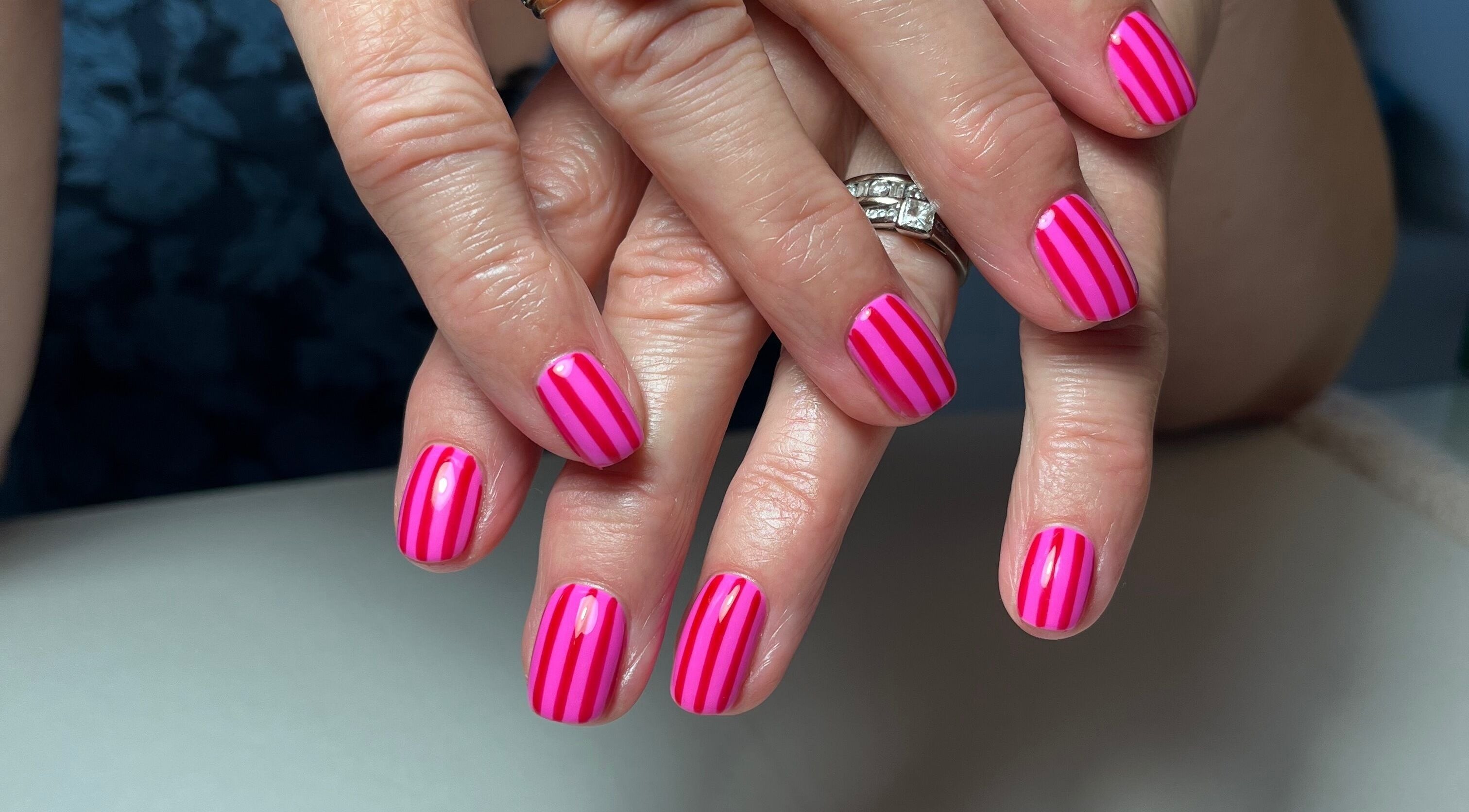 Pink striped manicure at Samanails in Broughshane, Northern Ireland, GB showing elegant nail art.