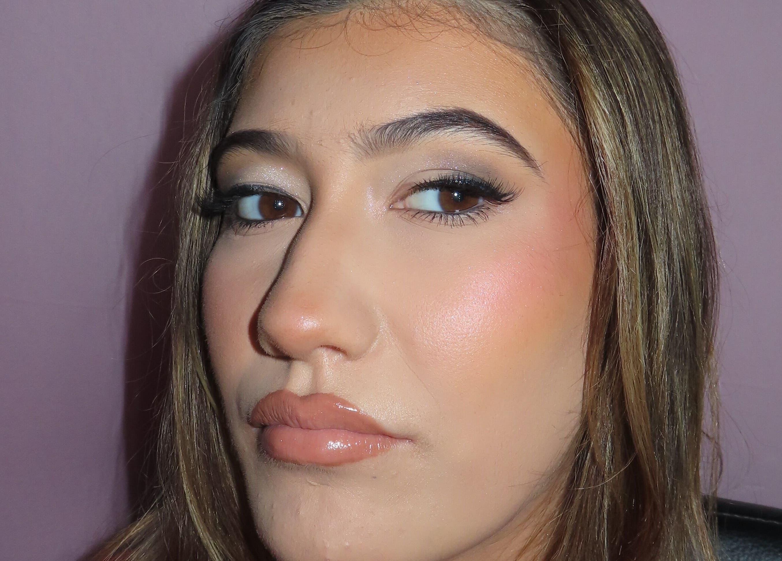 Close-up of a woman's face with flawless makeup at Dazzle Den, Douglas, Douglas, IM.