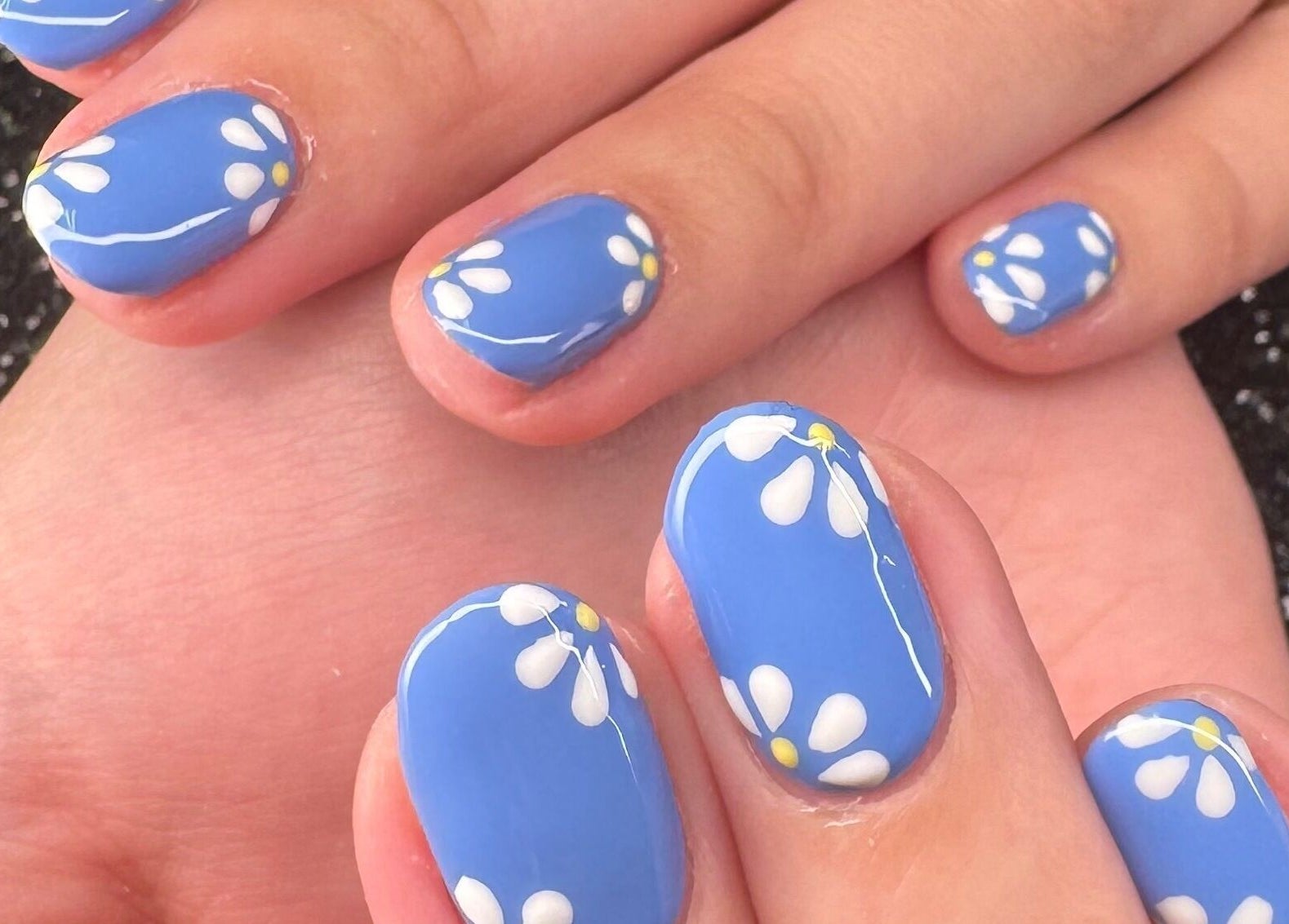 Blue nails with daisy designs at Nazia Sandhu - Permanent Makeup and Nails, Wokingham, England, GB.