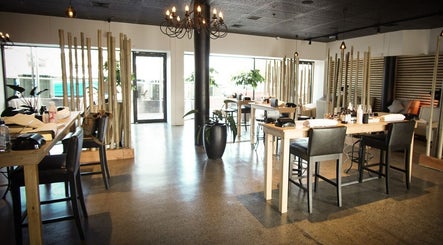 Spacious salon at The Art of Nails Ponsonby, Auckland, NZ featuring stylish wood decor and manicure stations.