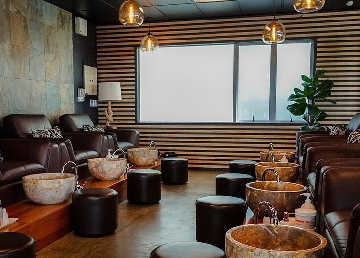 Luxurious pedicure setup at The Art of Nails Albany, Auckland, Auckland, NZ, showcasing plush seating and marble basins.