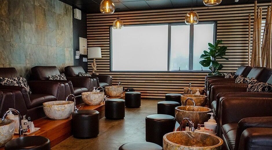 Luxurious pedicure setup at The Art of Nails Albany, Auckland, Auckland, NZ, showcasing plush seating and marble basins.
