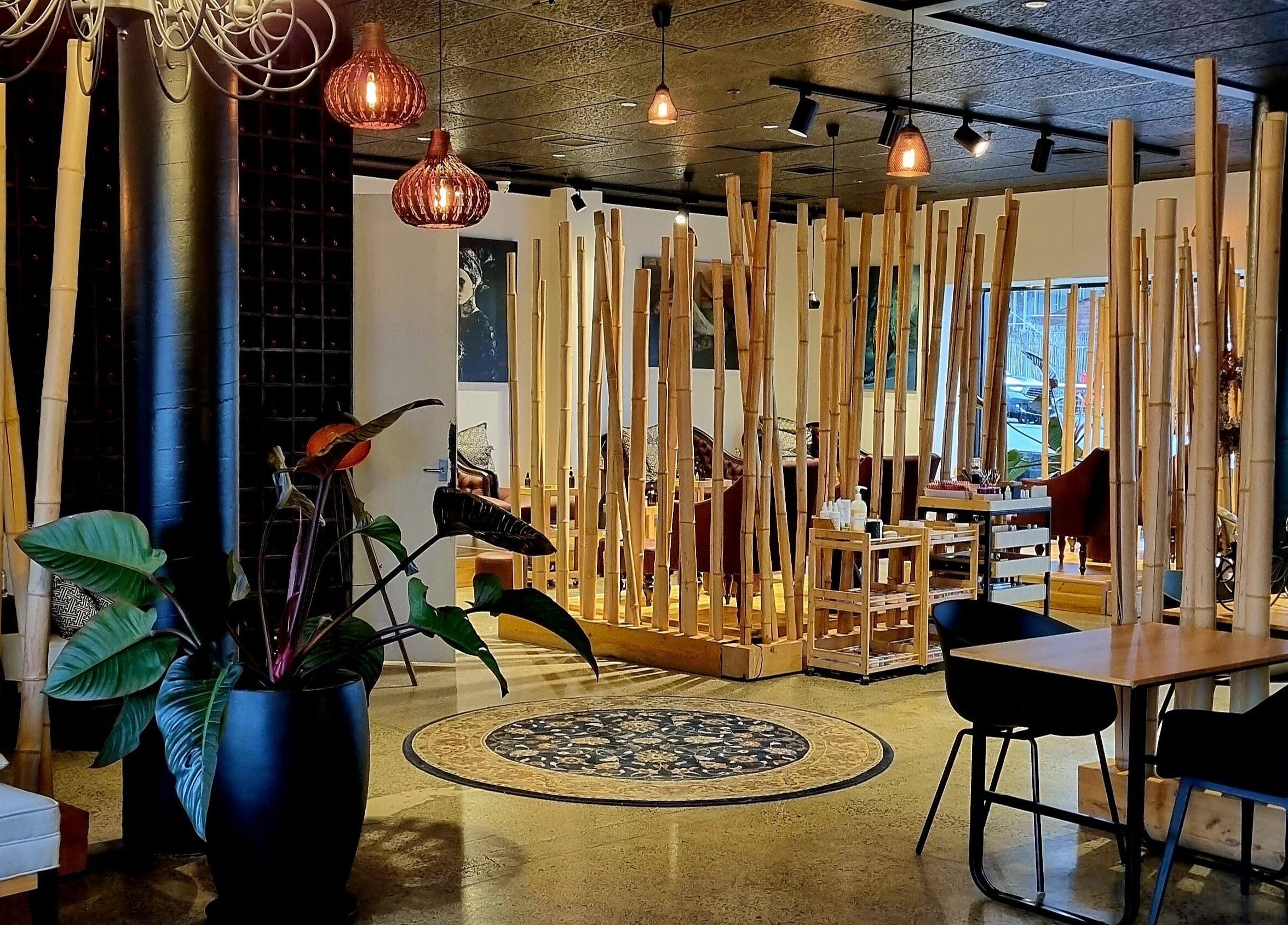 Relaxing lounge at The Art of Nails Ponsonby in Auckland, Auckland, NZ, with bamboo decor and cozy seating.
