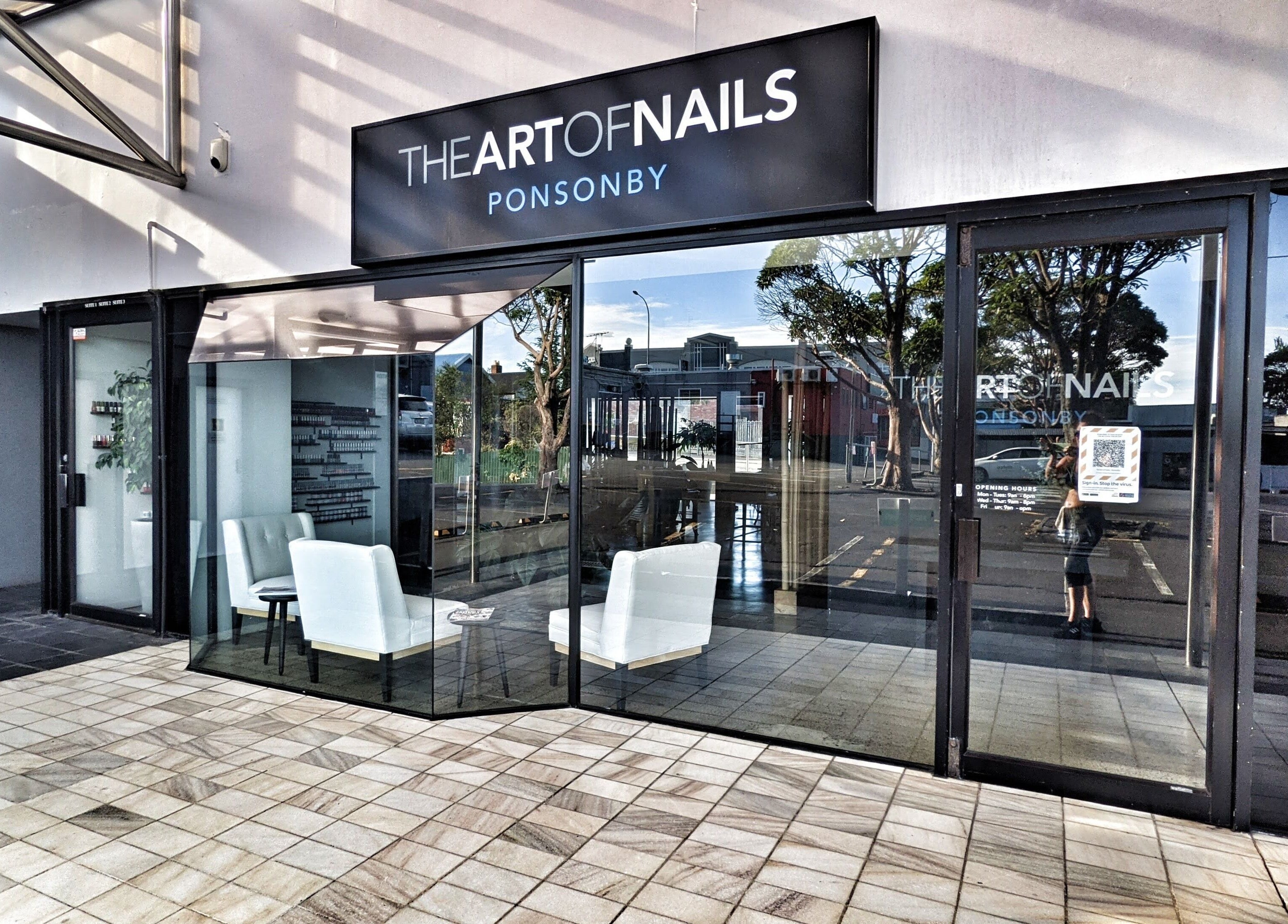 Glass-front entrance of The Art of Nails Ponsonby, Auckland, Auckland, NZ with stylish seating.