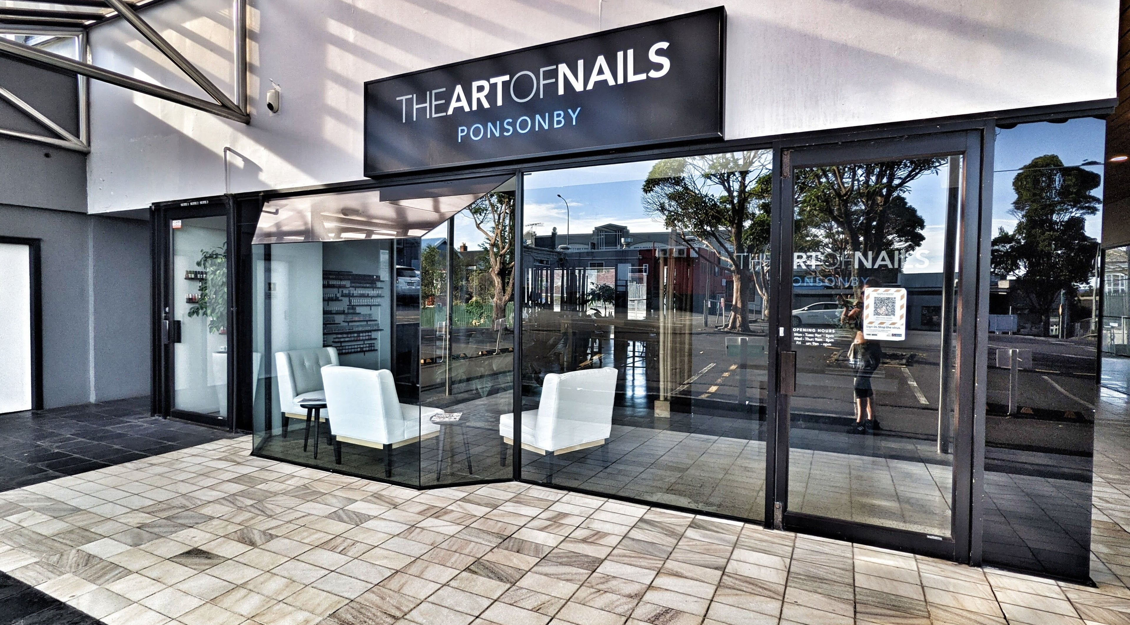 Glass-front entrance of The Art of Nails Ponsonby, Auckland, Auckland, NZ with stylish seating.