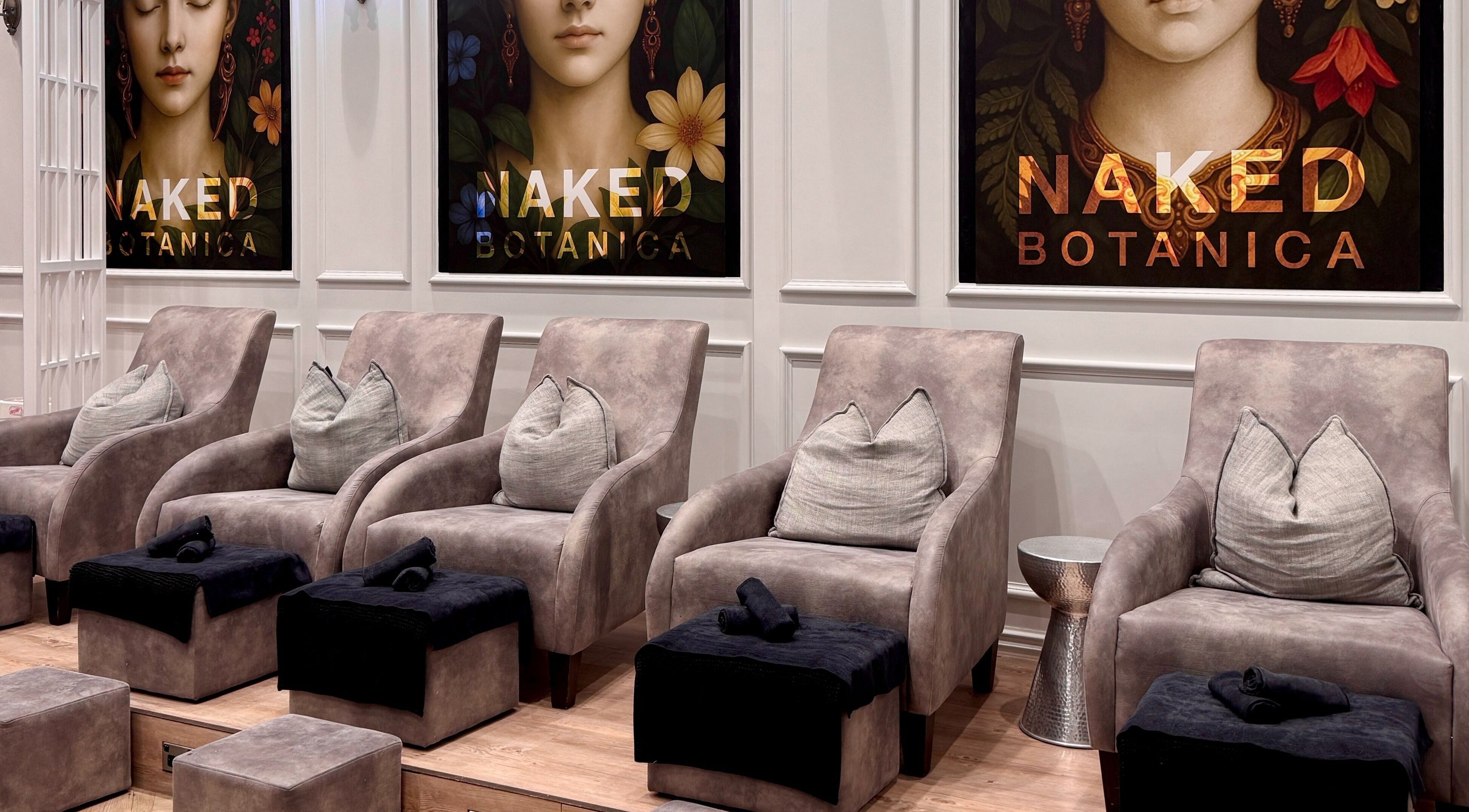 Luxurious seating at Naked Botanica by The Art of Nails Newmarket, Auckland, Auckland, NZ; plush chairs invite relaxation.