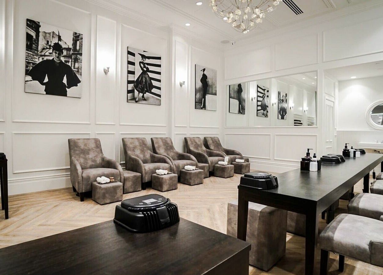 Chic interior of Naked Botanica by The Art of Nails Newmarket, Auckland, NZ, showcasing elegant seating and decor.