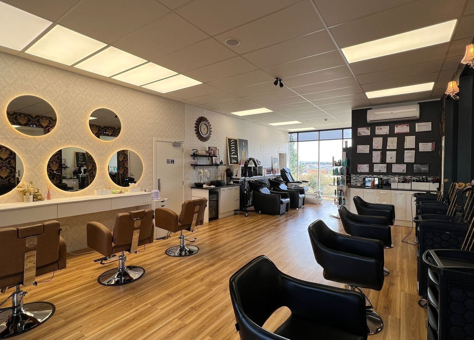 Interior of Shine Magic Touch Rototuna salon in Hamilton, Waikato, NZ, with chic chairs and illuminated mirrors.