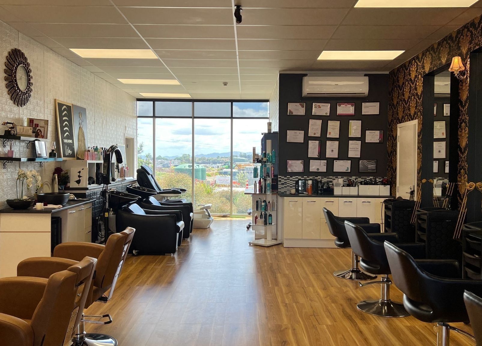 Interior of Shine Magic Touch Rototuna, Hamilton, Waikato, NZ; stylish salon with modern chairs and elegant decor.