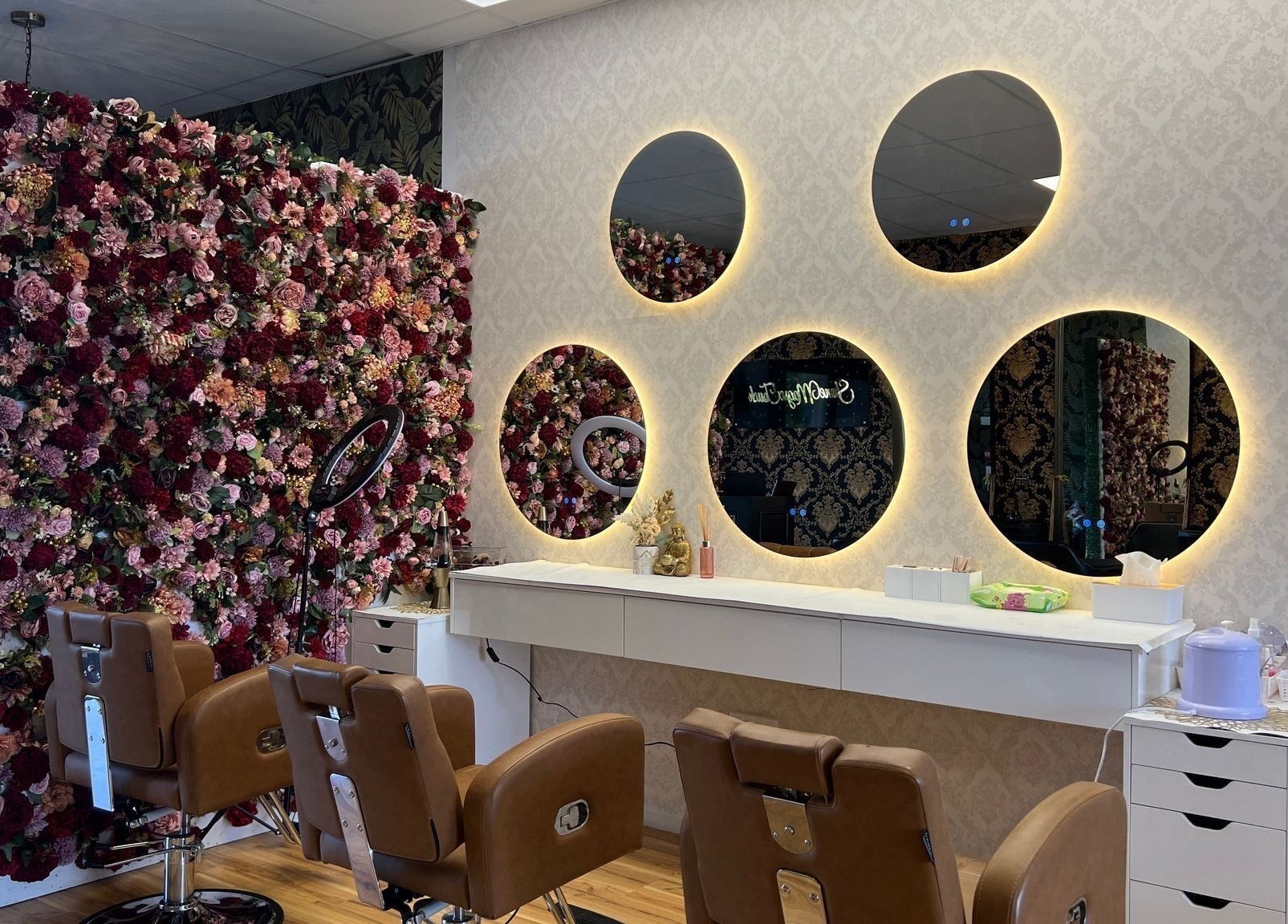 Chic beauty salon with floral wall and mirrors at Shine Magic Touch Rototuna, Hamilton, Waikato, NZ.
