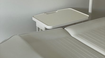 Treatment room at DOLLY DENTAL - TEETH WHITENING & TOOTH GEMS, Maroochy River, Queensland, AU with a white dental chair.