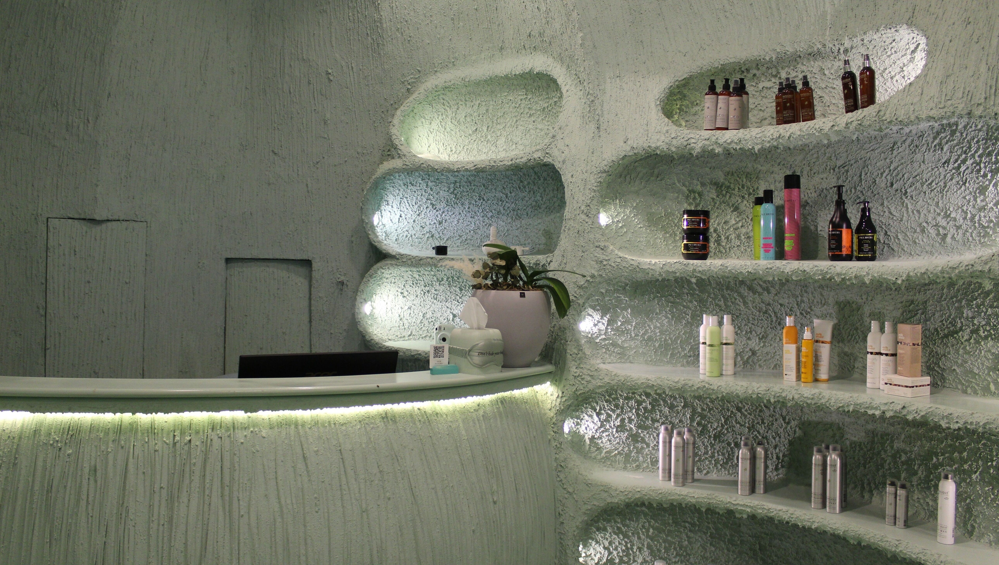 Modern, stylish interior of Hide Beauty Center, Sharjah with shelves of products and gentle lighting.