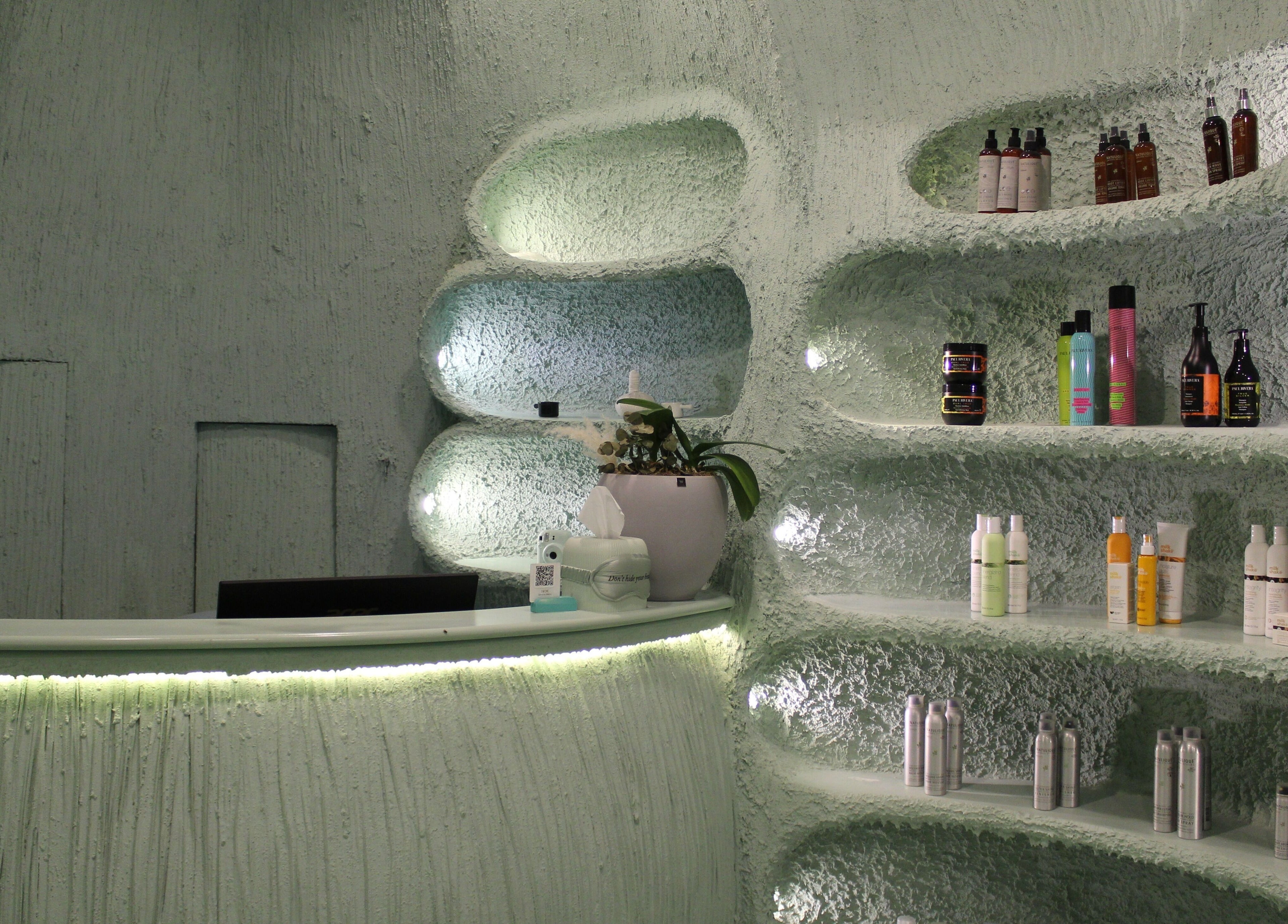 Modern, stylish interior of Hide Beauty Center, Sharjah with shelves of products and gentle lighting.