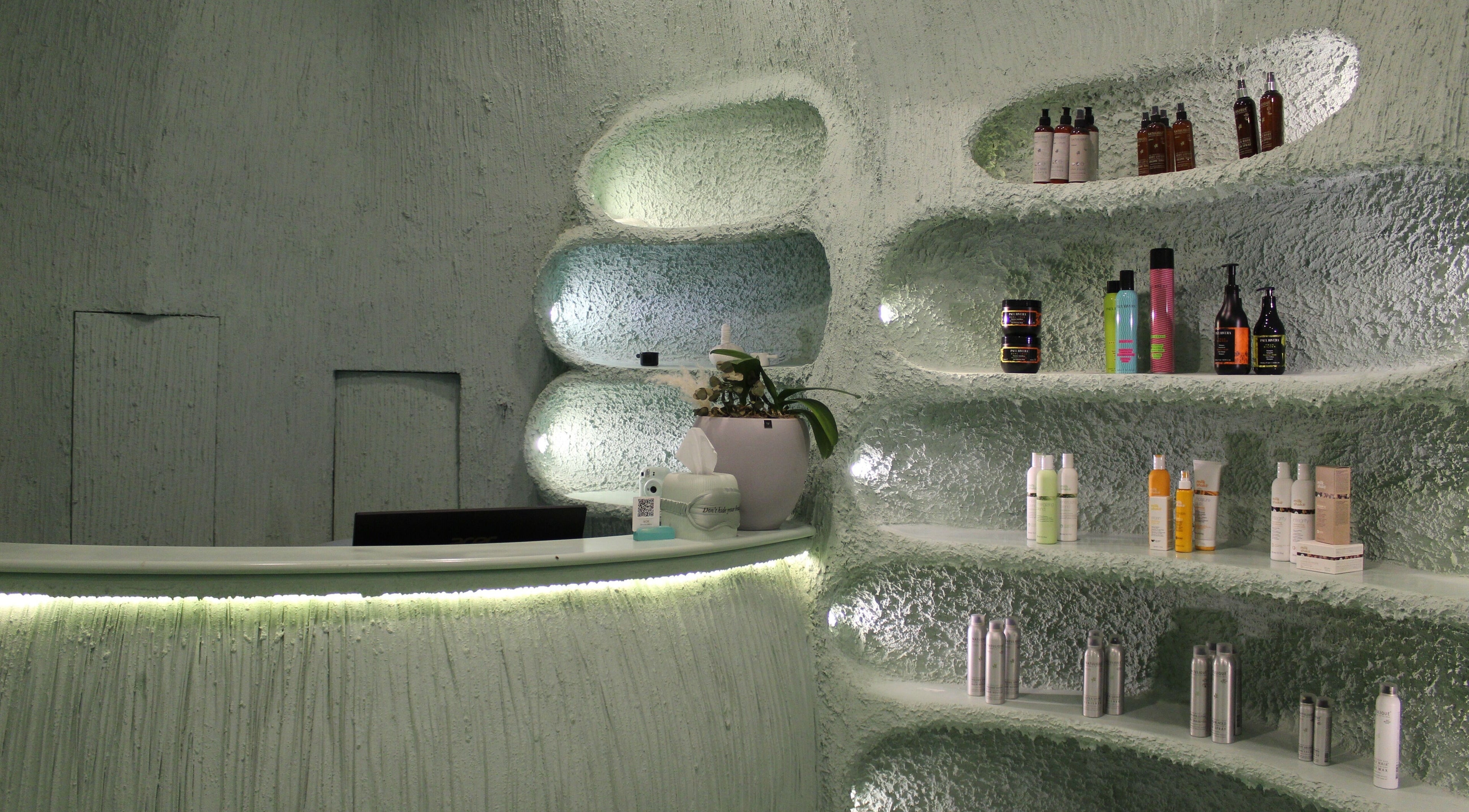 Modern, stylish interior of Hide Beauty Center, Sharjah with shelves of products and gentle lighting.