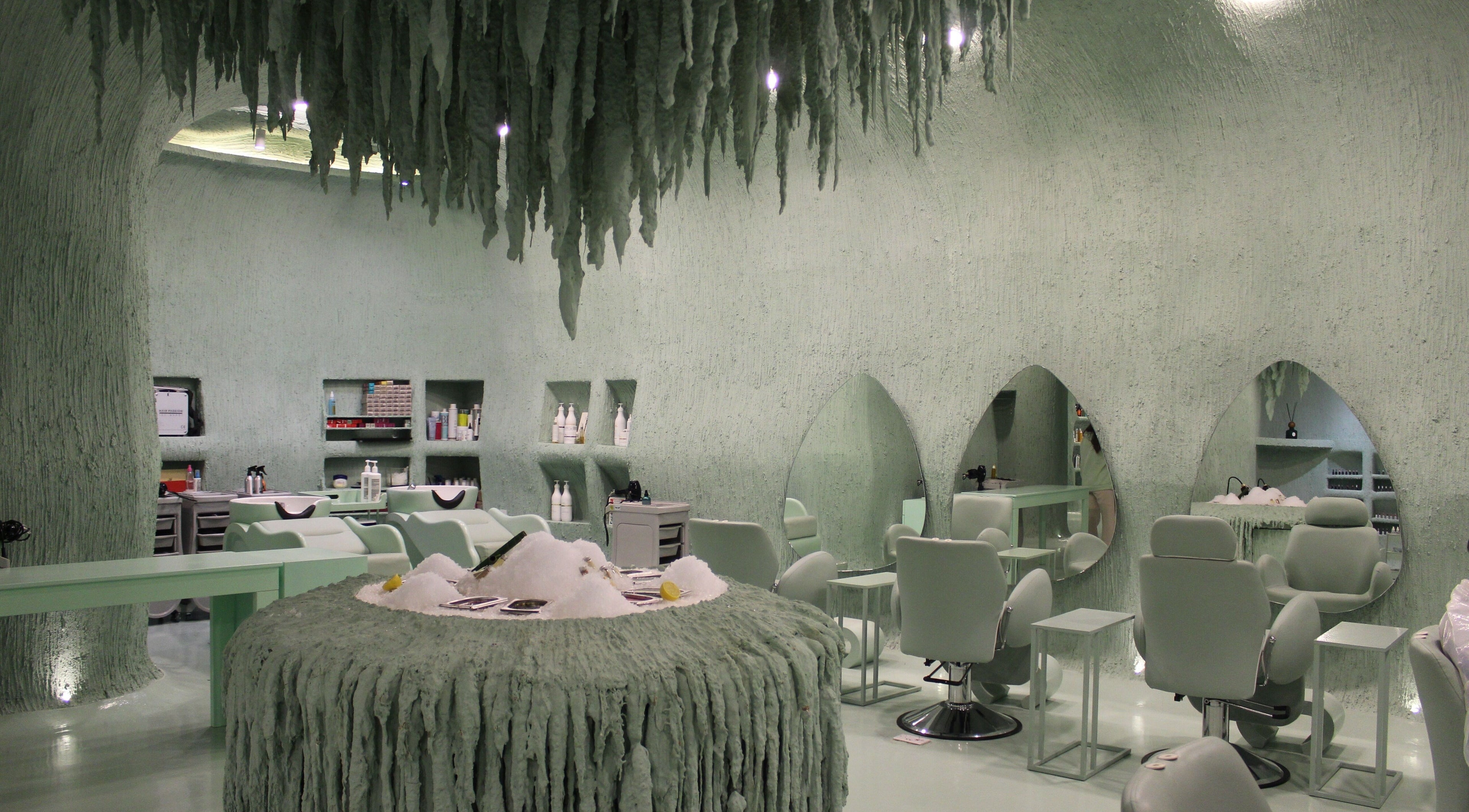 Stylish interior of Hide Beauty Center in Sharjah, AE, featuring modern salon chairs and unique design.