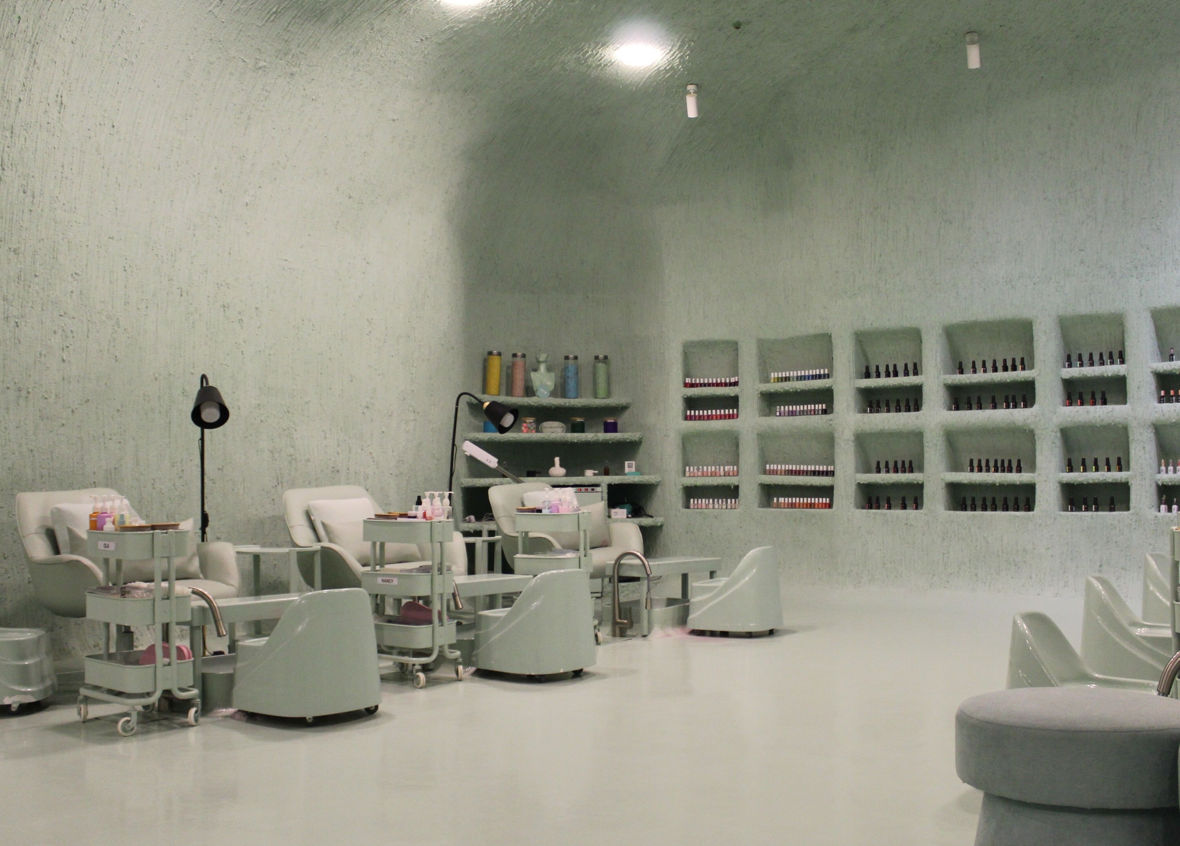 Elegant nail salon at Hide Beauty Center in Sharjah, Sharjah, AE with modern decor and manicure stations.