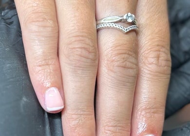 Manicured hand with silver ring at Glow By BG, Rotherham, England, GB, showcasing detailed nail art.