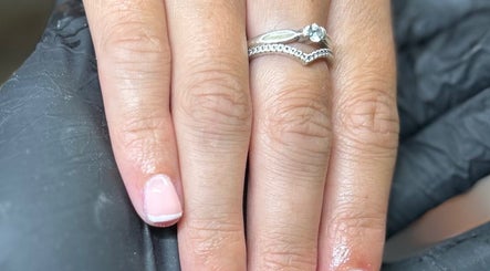 Manicured hand with silver ring at Glow By BG, Rotherham, England, GB, showcasing detailed nail art.