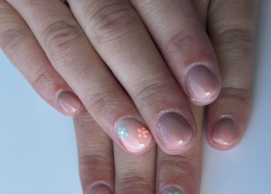 Beautiful floral nail art at Glow By BG, Rotherham, England, GB showcasing delicate hand design.