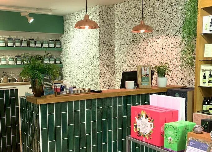 Interior of Balm in Royal Leamington Spa, England; showcasing chic decor with herbal products on display.