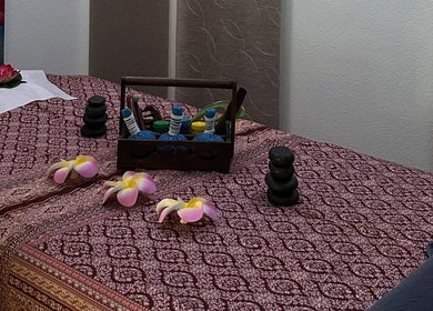 Elegant massage table setup at Blue Bamboo Thai Massage & Spa, Basel, Basel-stadt, CH with oils and flowers.