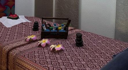 Elegant massage table setup at Blue Bamboo Thai Massage & Spa, Basel, Basel-stadt, CH with oils and flowers.