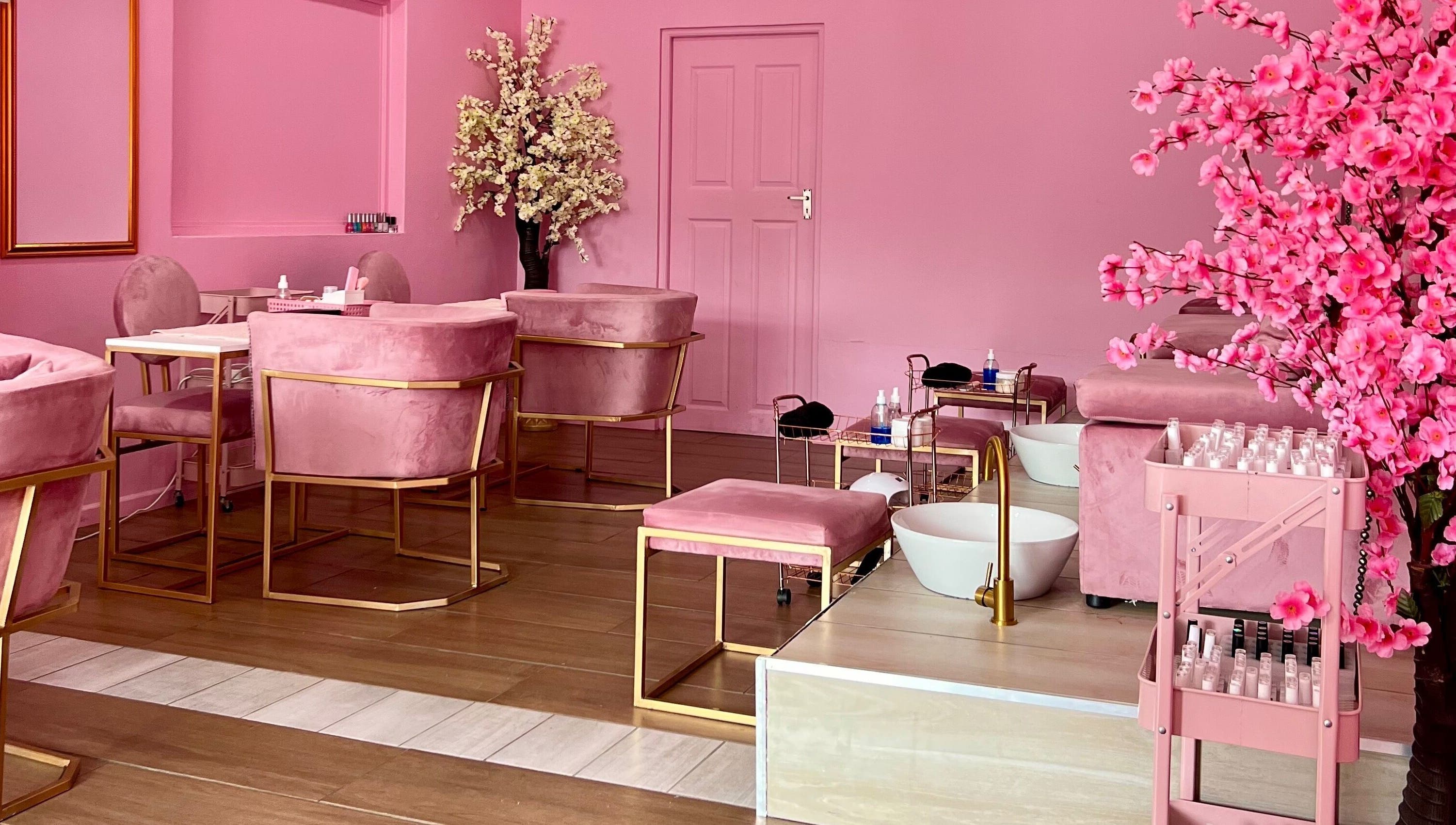 Chic pink interior of ROZÏÏ JŪ, East London, Eastern Cape, ZA, featuring plush chairs and elegant décor elements.