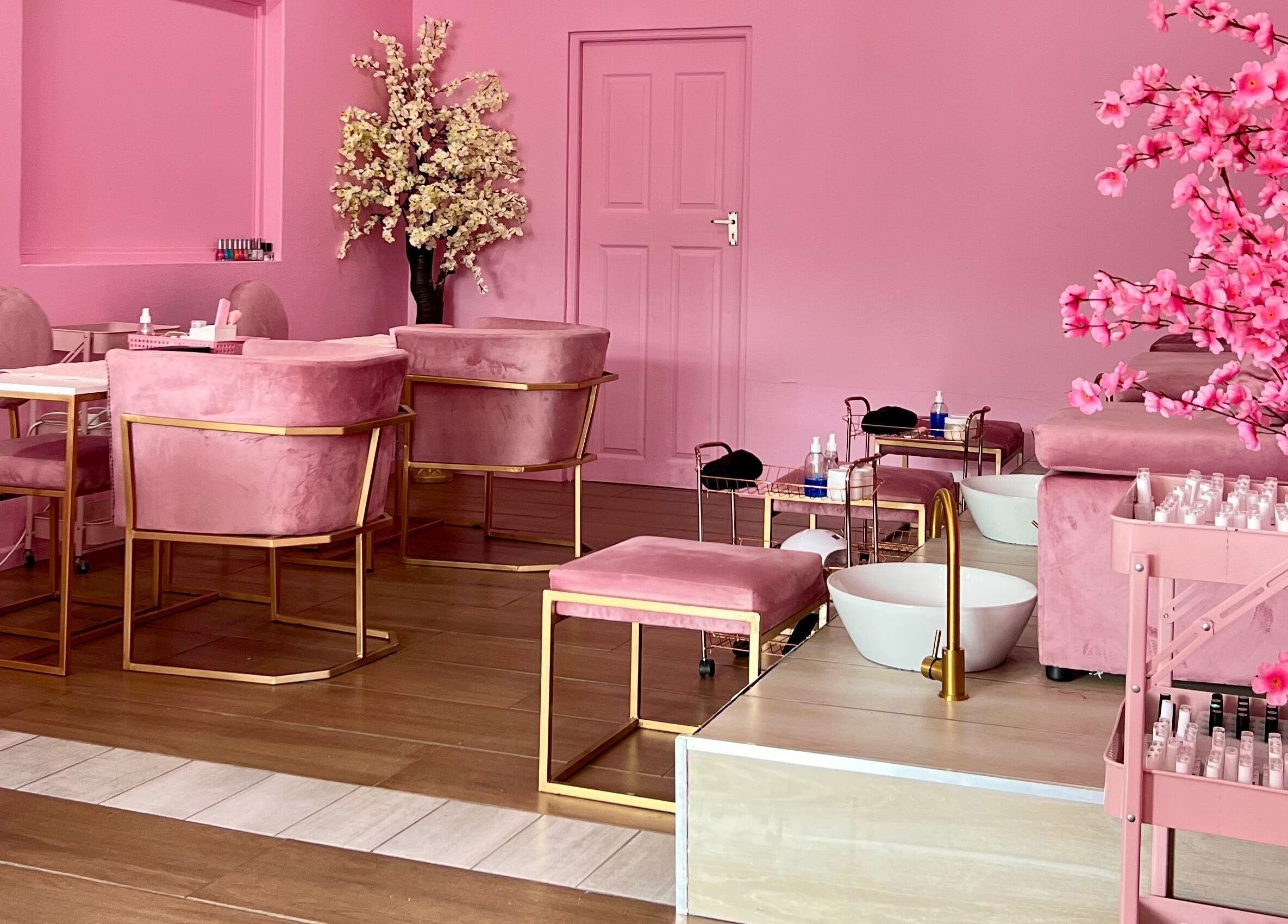 Chic pink interior of ROZÏÏ JŪ, East London, Eastern Cape, ZA, featuring plush chairs and elegant décor elements.
