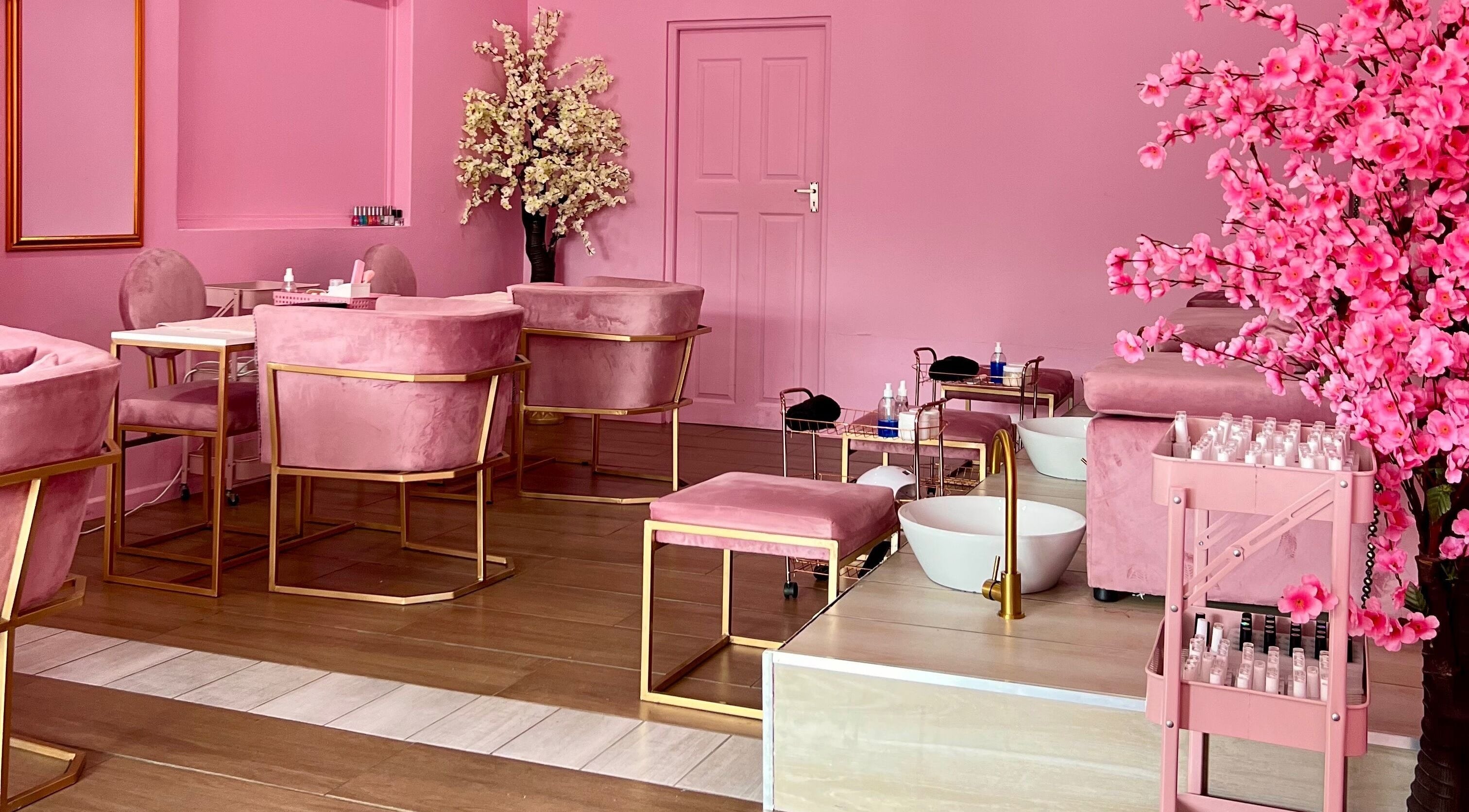 Chic pink interior of ROZÏÏ JŪ, East London, Eastern Cape, ZA, featuring plush chairs and elegant décor elements.