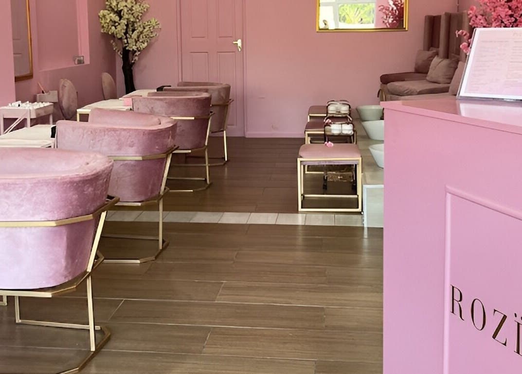 Interior of ROZÏÏ JŪ, East London, Eastern Cape, ZA: luxurious pink chairs and decor in a serene beauty salon.