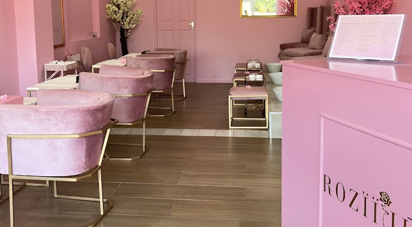 Interior of ROZÏÏ JŪ, East London, Eastern Cape, ZA: luxurious pink chairs and decor in a serene beauty salon.